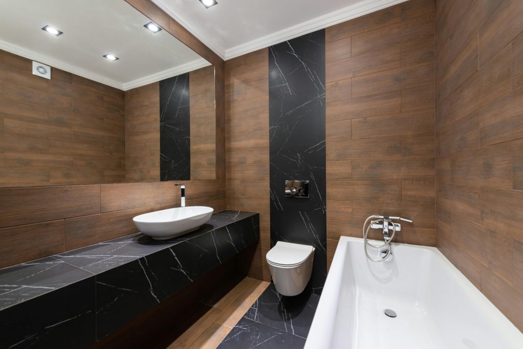 pexels-photo-7045358-7045358 Modern bathroom with wooden accents, sleek fixtures, and minimalist design.